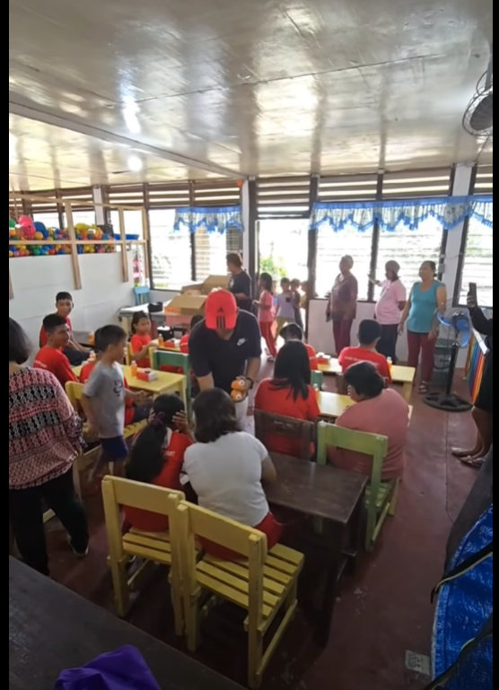 Community feeding activity supported by Kuya Ely Tours