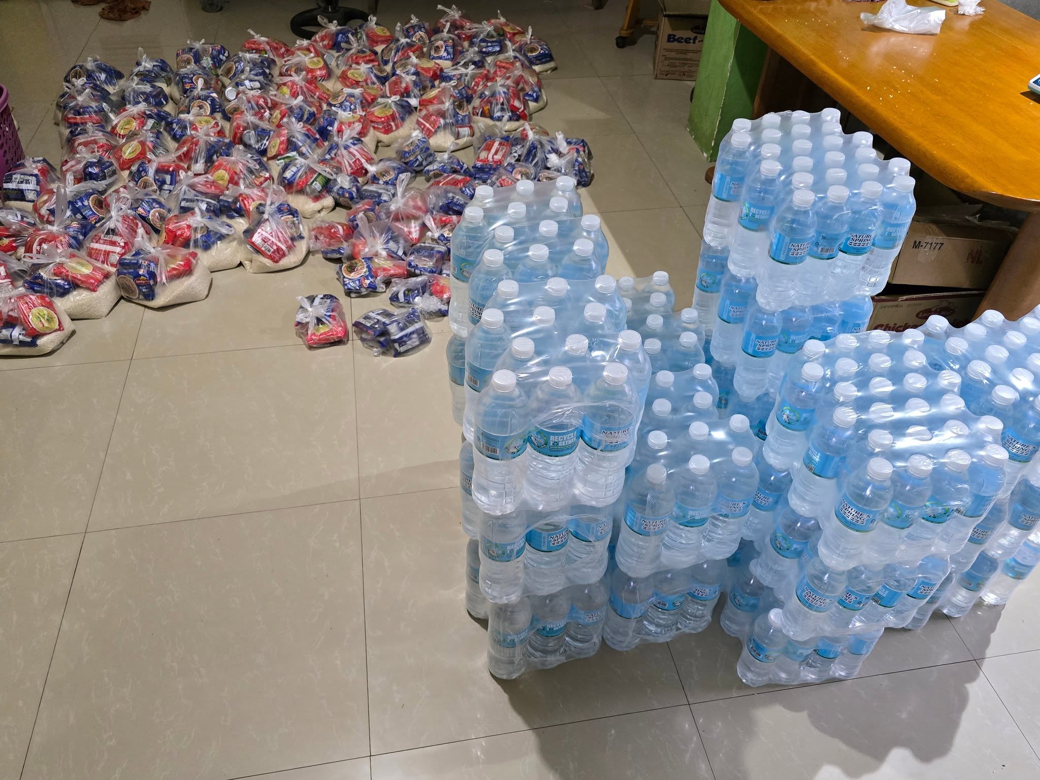 Rice packs and bottled water prepared for community relief