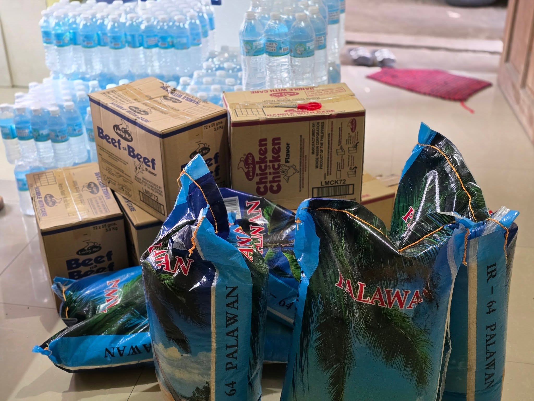 Relief packs of rice, water, and canned goods ready for distribution