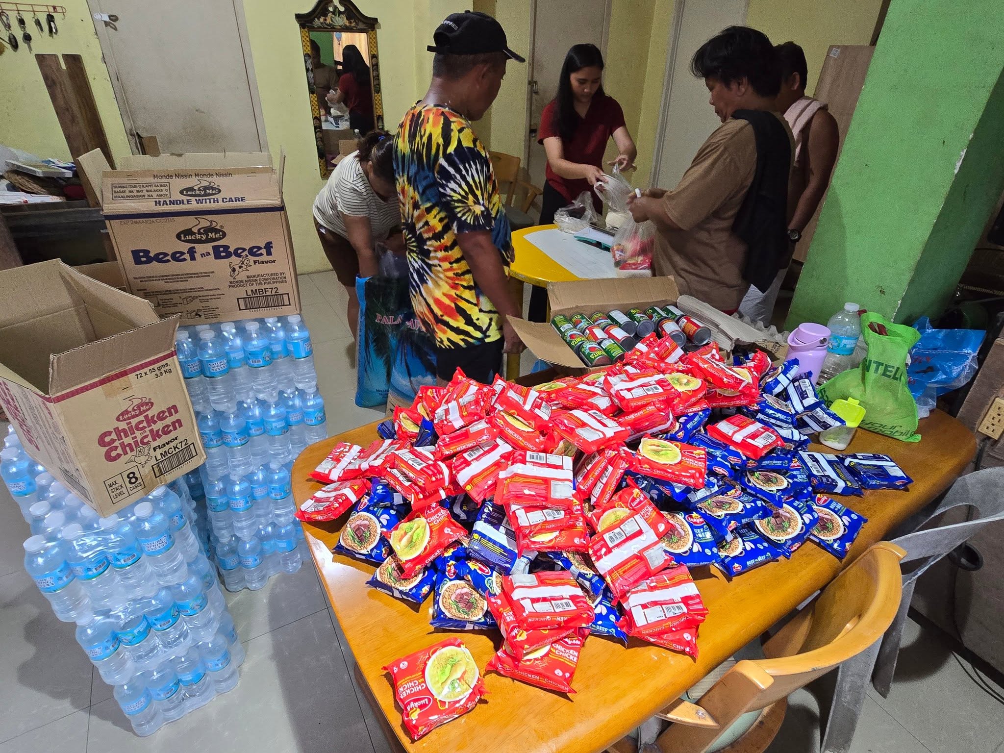 Volunteers packing rice, water, and relief goods